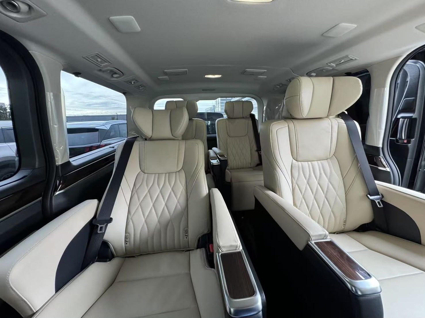 Cream leather diamond-stitched captain seats inside a Toyota Alphard