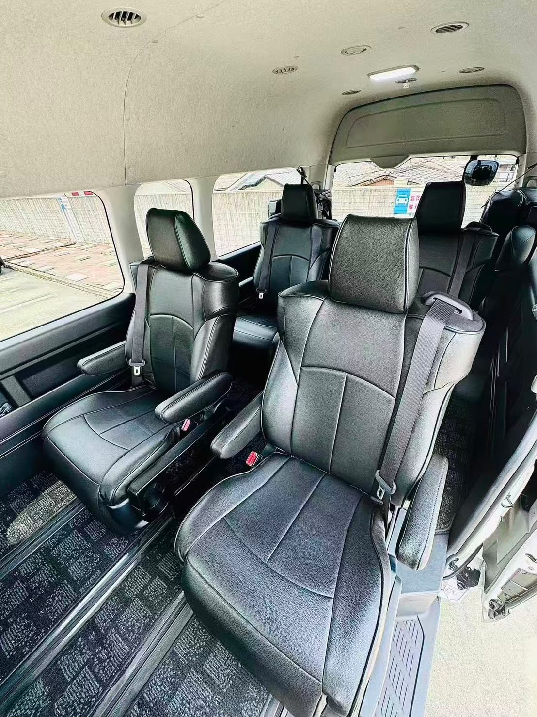 Black leather captain seats inside a Toyota Hiace