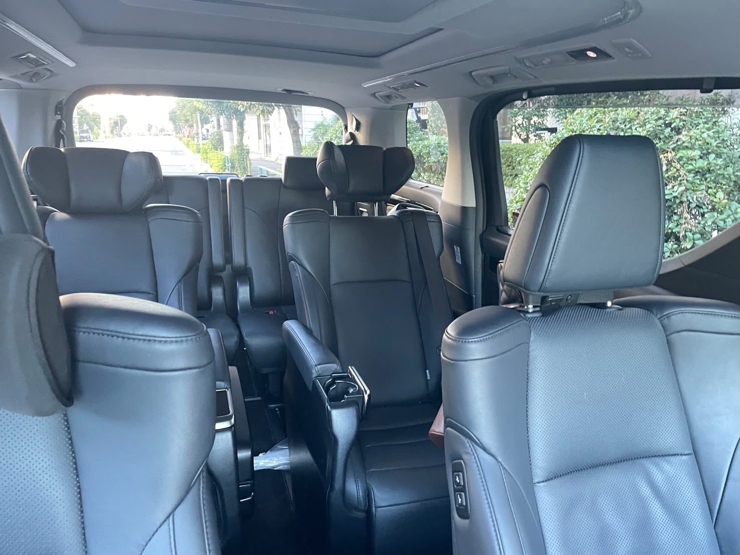 Three rows of black leather seating inside a minivan